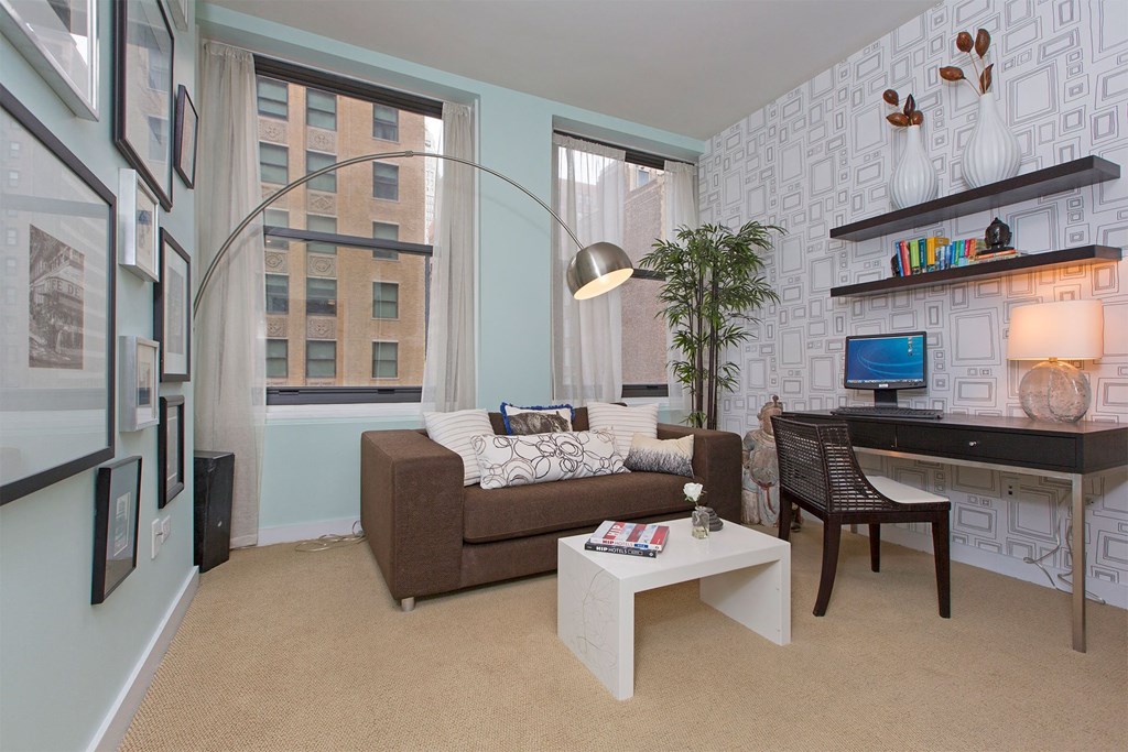 a living room with a couch and a desk