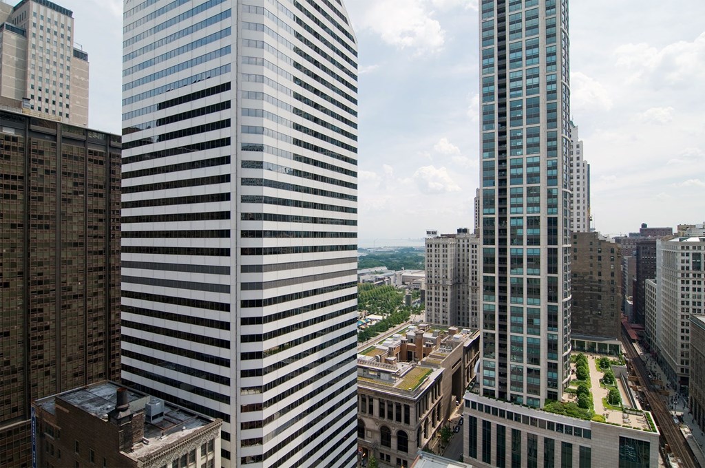 two tall skyscrapers with a city in the background