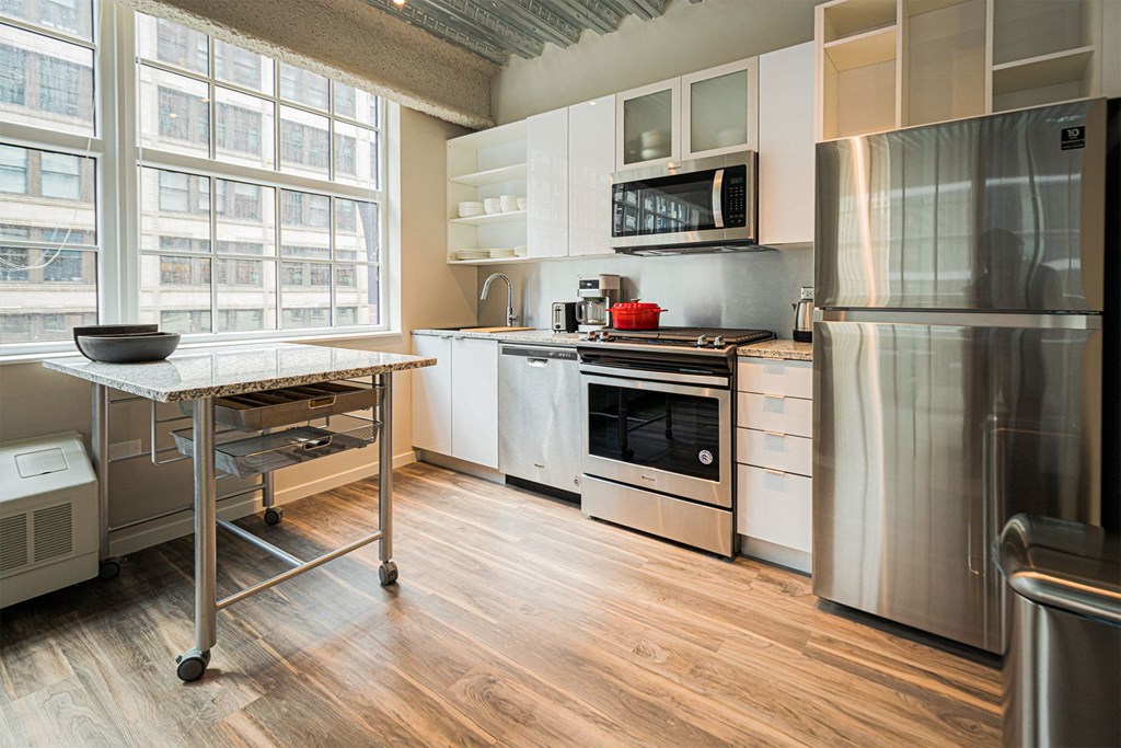 a kitchen with stainless steel appliances and a table