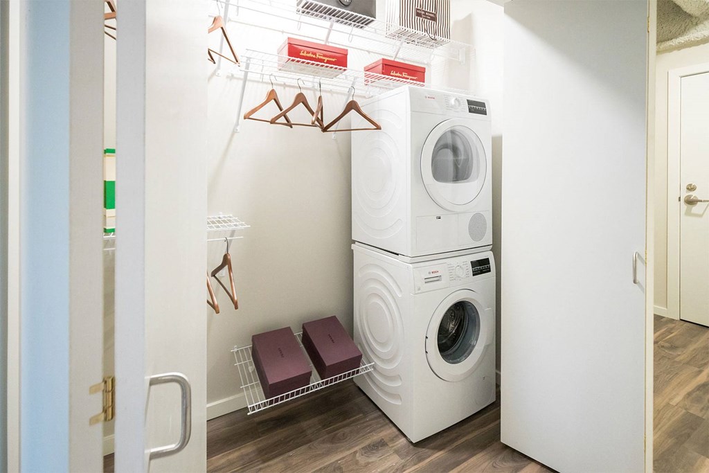 a white laundry room with a washing machine and a dryer