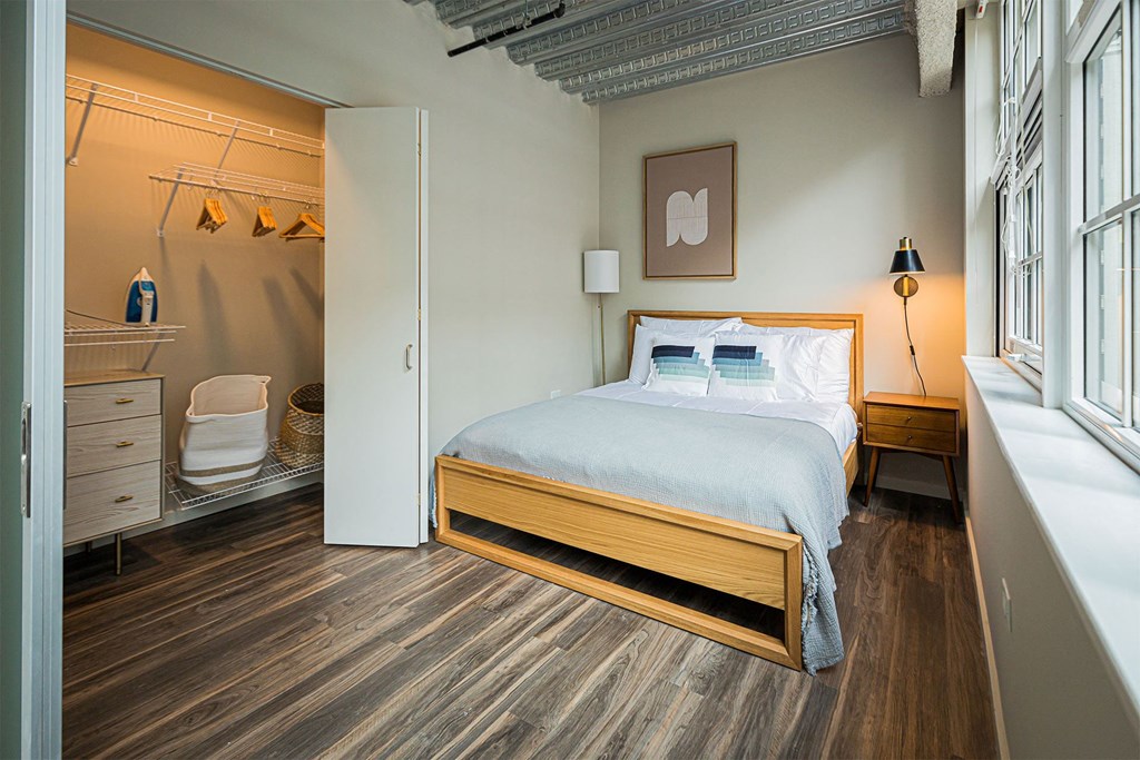 a bedroom with a bed and a bathroom with a shower