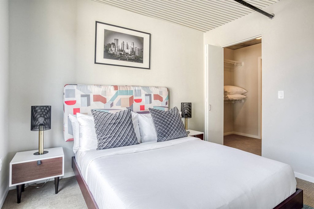 a bedroom with a large bed and a closet