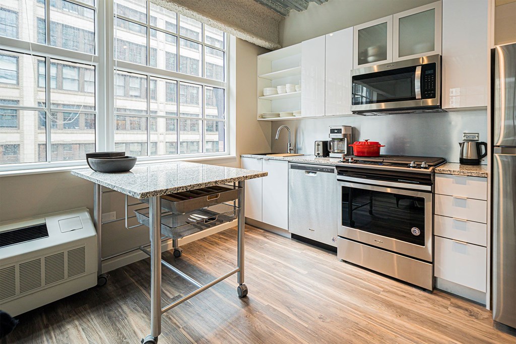 a kitchen with stainless steel appliances and a table