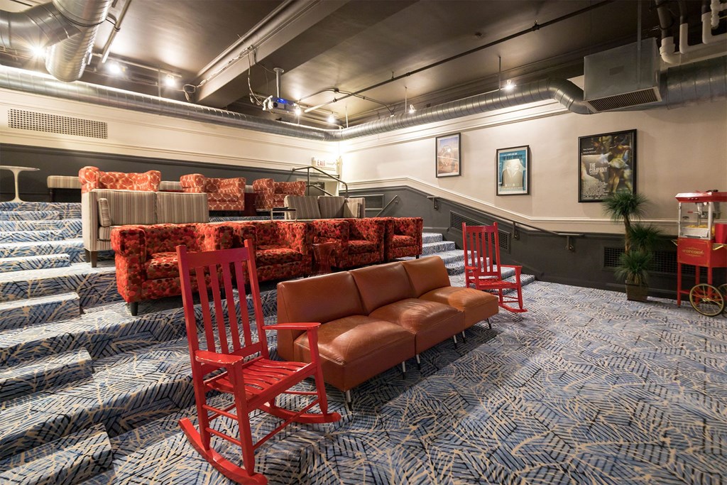 a large room with red chairs and couches and a seating area