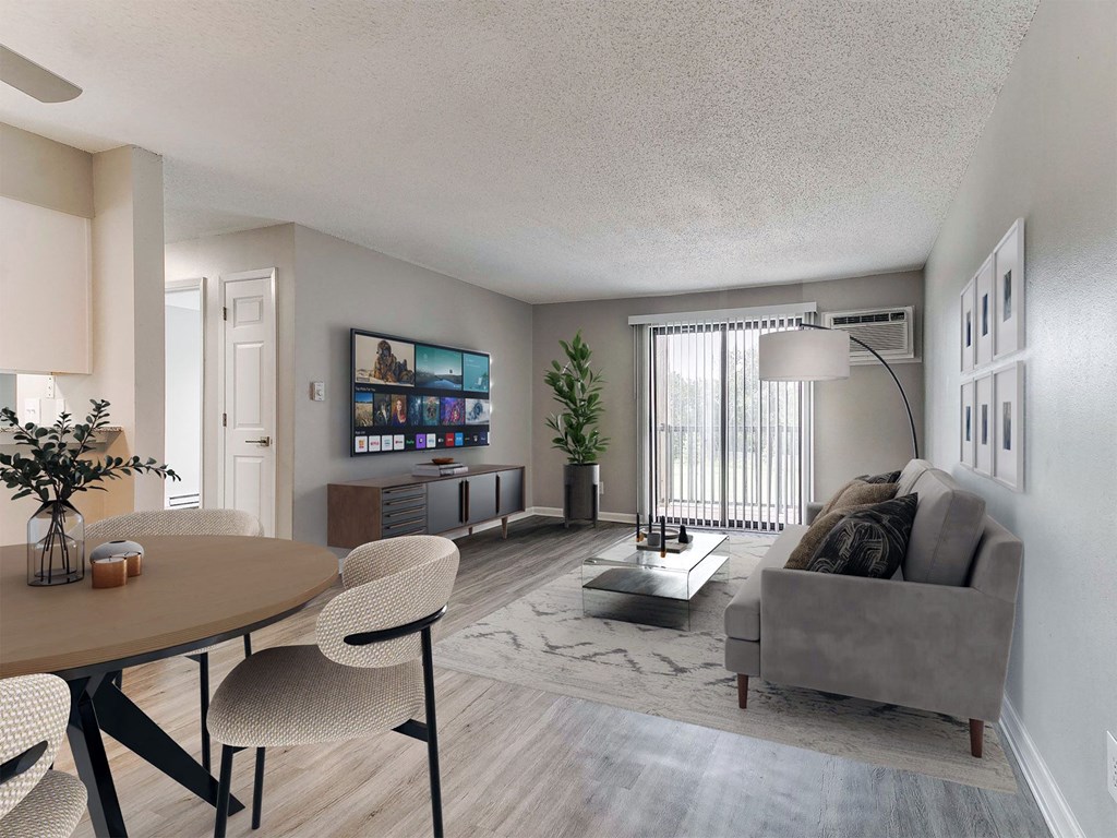 a living room and dining room with a couch and a table