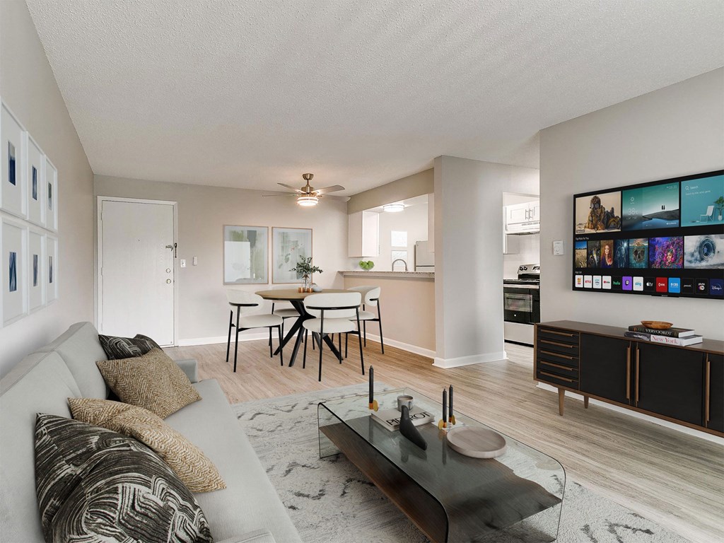 Premium Finish Package a living room with a couch and a coffee table in front of a dining area
