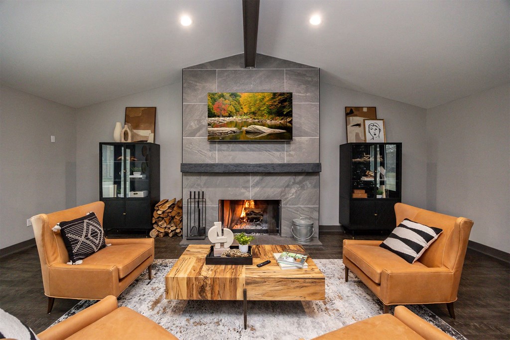 A modern living room with a fireplace and two chairs.