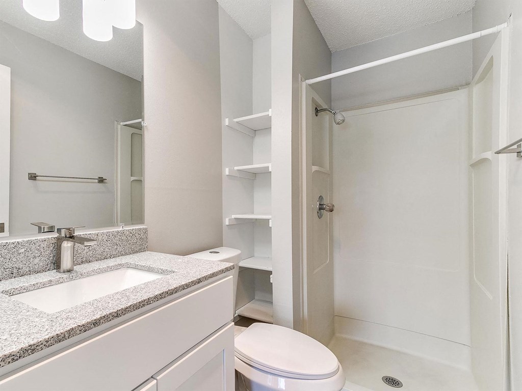 a bathroom with a sink toilet and a shower