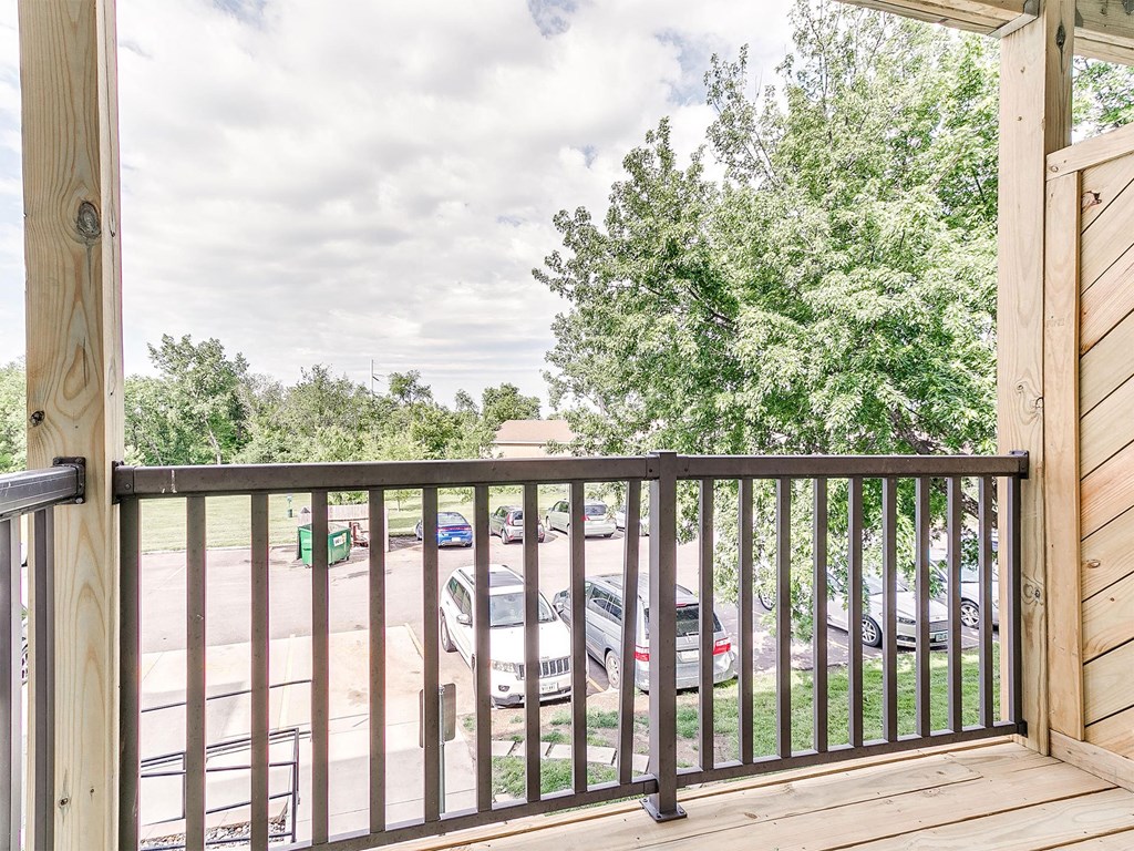 the balcony has a view of the parking lot