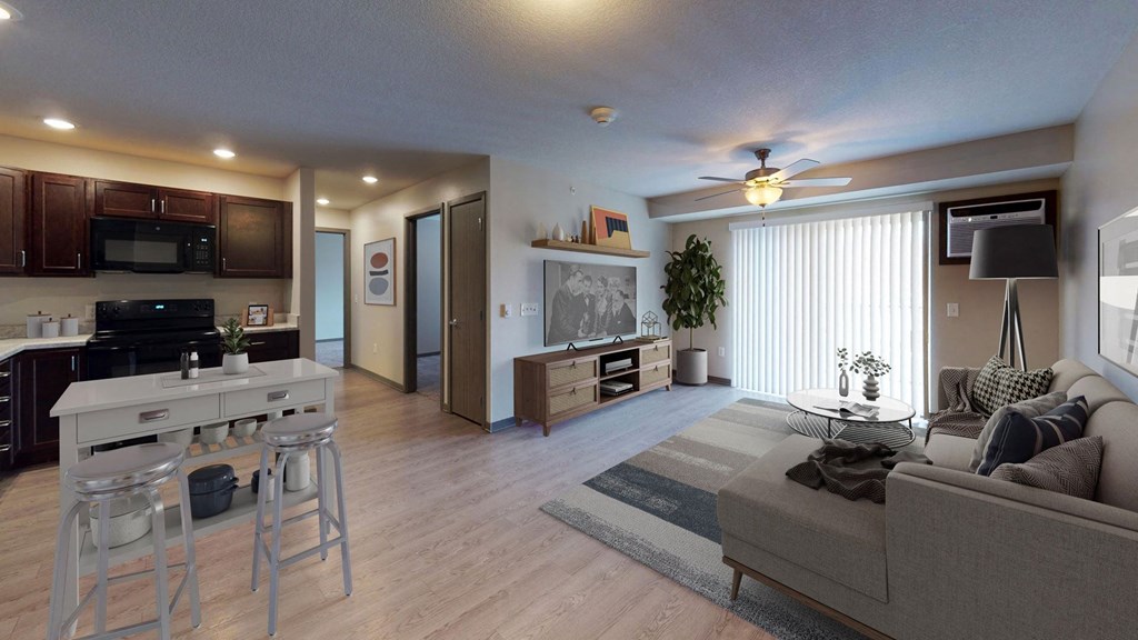 a living room and kitchen with a couch and a table