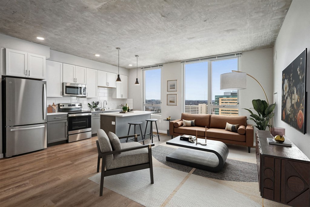 A modern kitchen with a refrigerator, oven, and microwave.