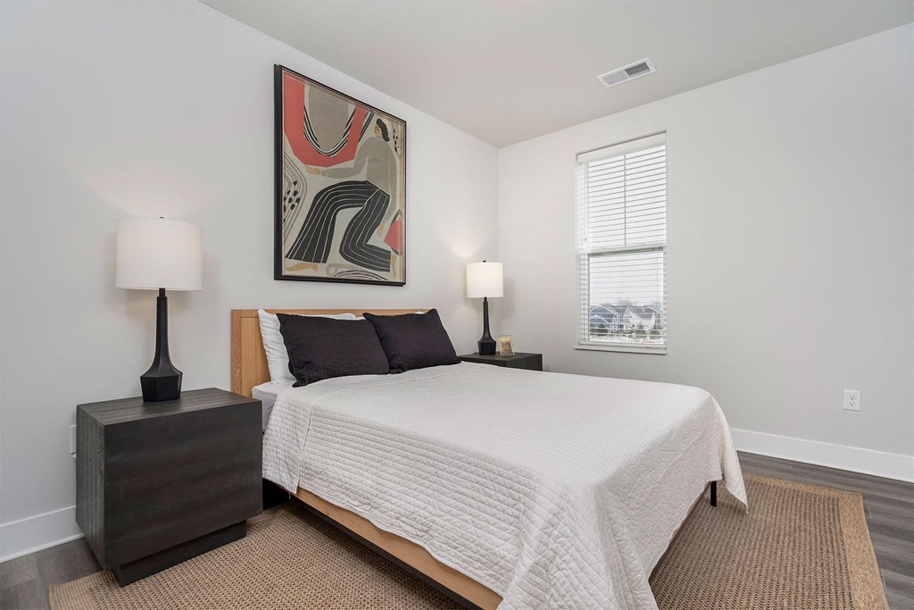 a bedroom with a bed and a window