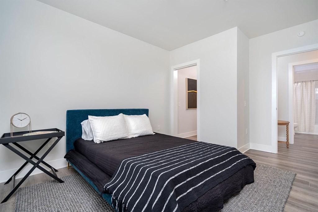 a bedroom with a bed and a door to a bathroom