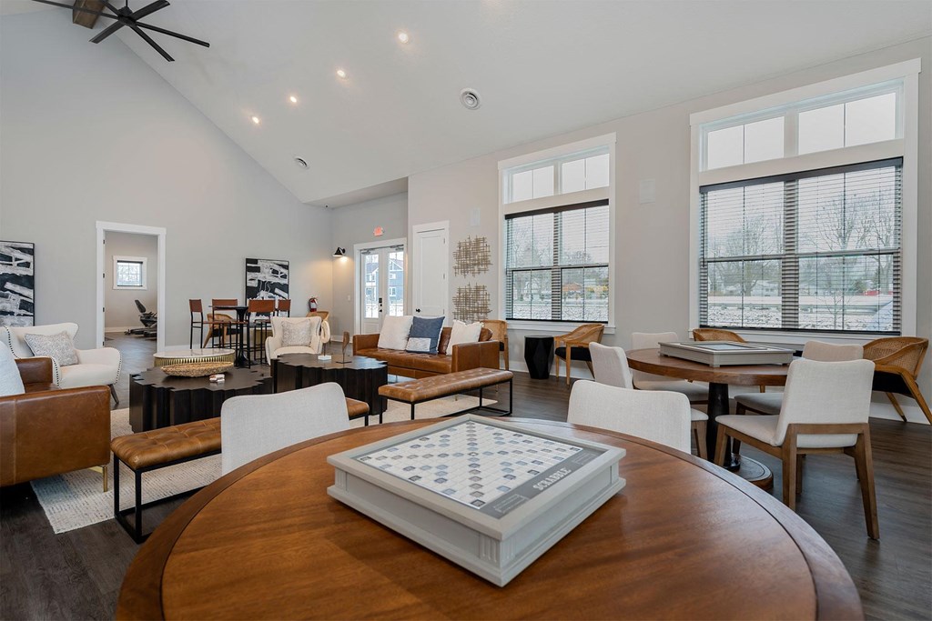 a living room with chairs and tables and a table chess board