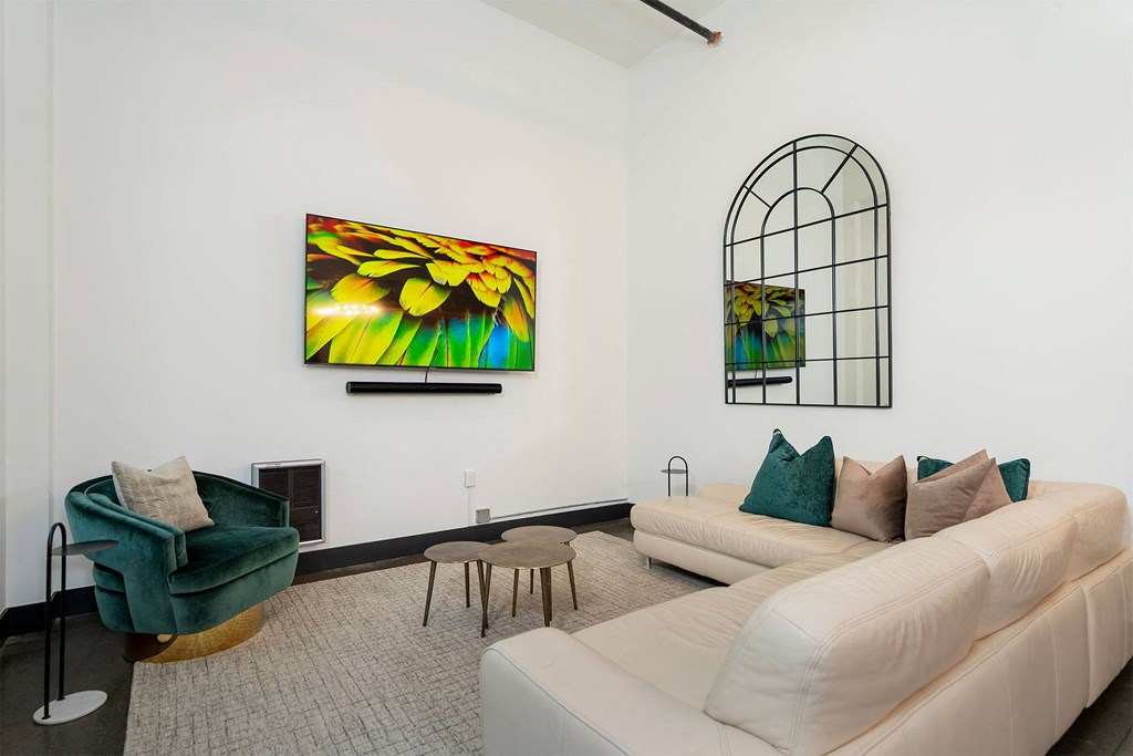 a living room with a white couch and a window