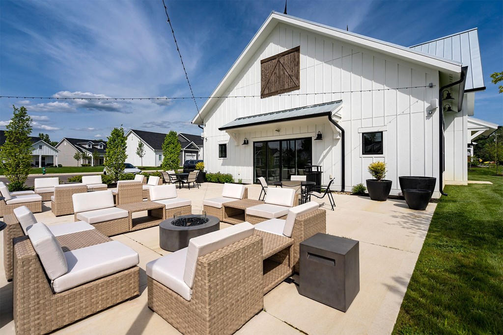 the outdoor patio of a home with furniture and a fire pit
