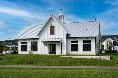 the front of a white church with a metal roof