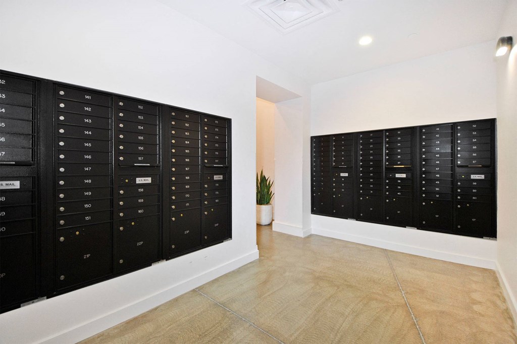 the room has a locker room with wooden floors and white walls