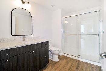a bathroom with a toilet and a shower