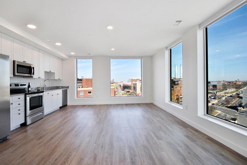 an open kitchen and living room with a view of the city