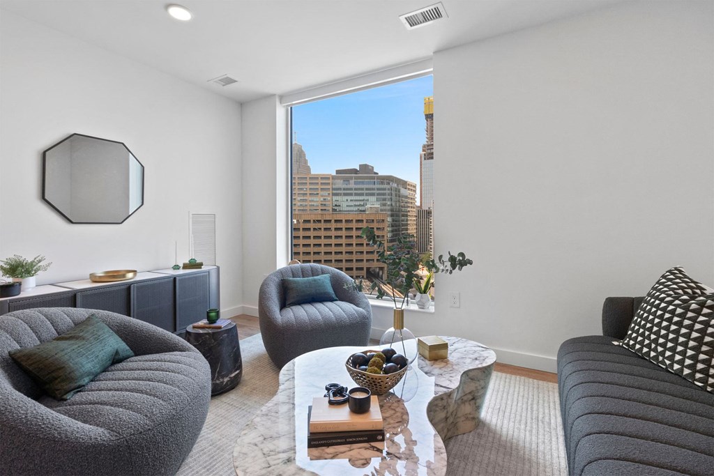 a living room with a large window and a couch and a coffee table