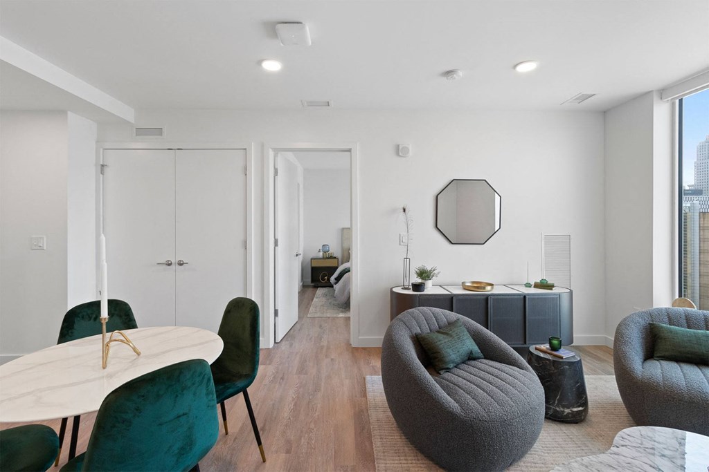 a living room with a couch and a table and chairs