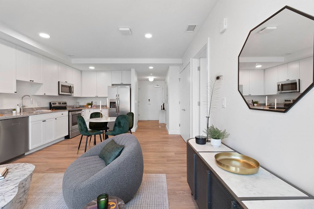 an open living room with a kitchen and a dining room