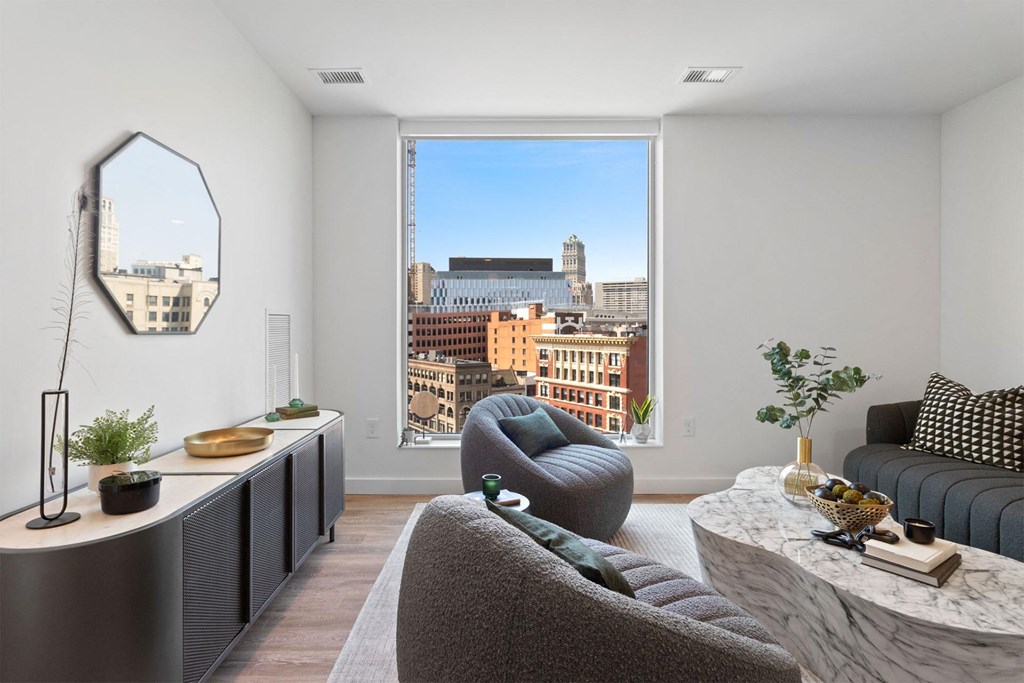a living room with a large window overlooking the city