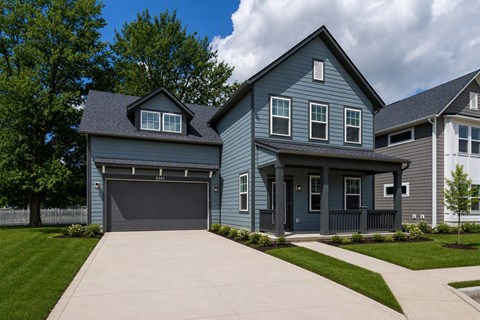 A house with a grey garage door and a grey front door.