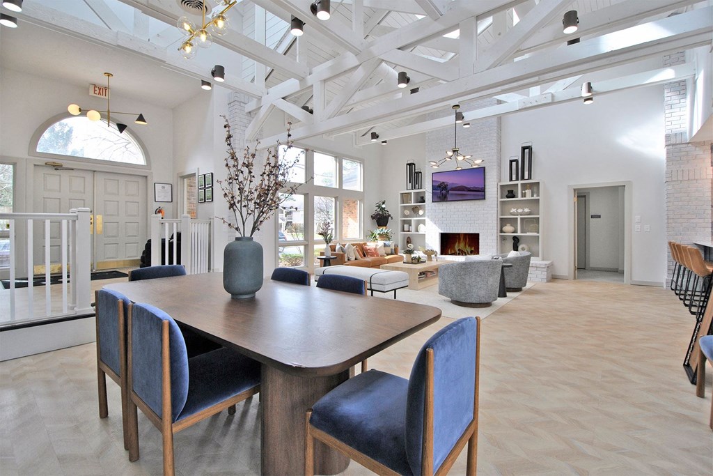 a dining room and living room with a table and chairs