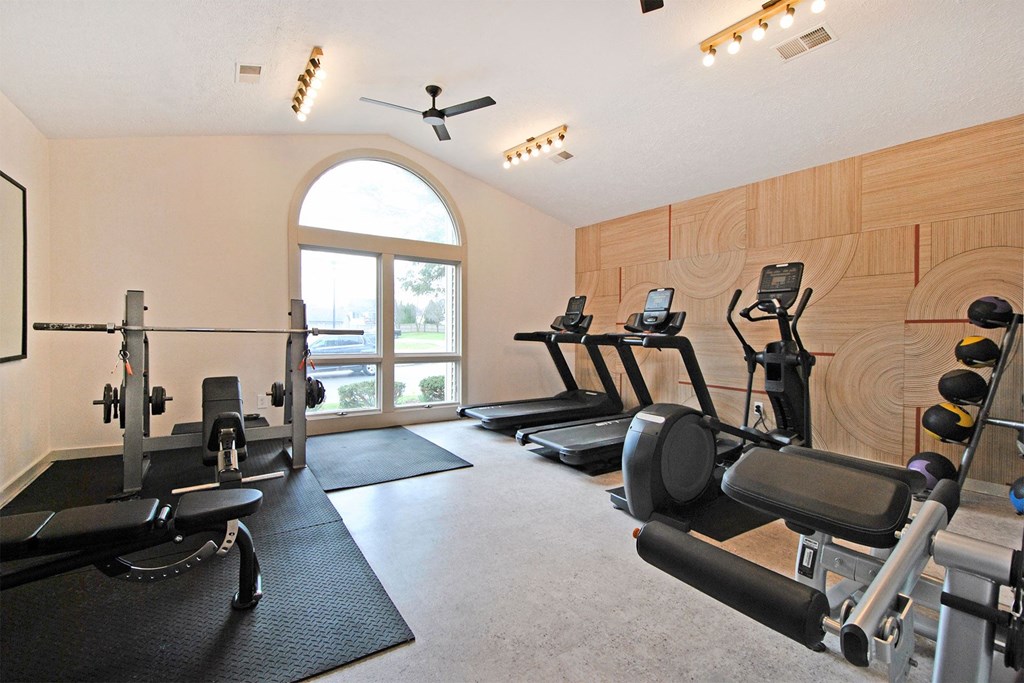 a gym with exercise equipment and a window