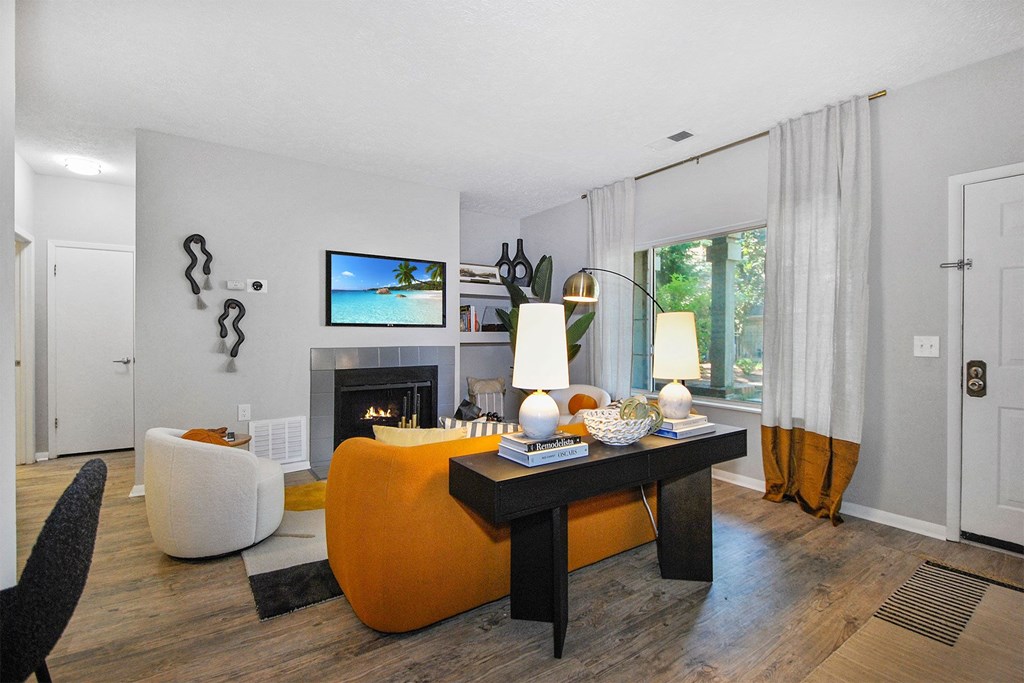 a living room with an orange couch and a table