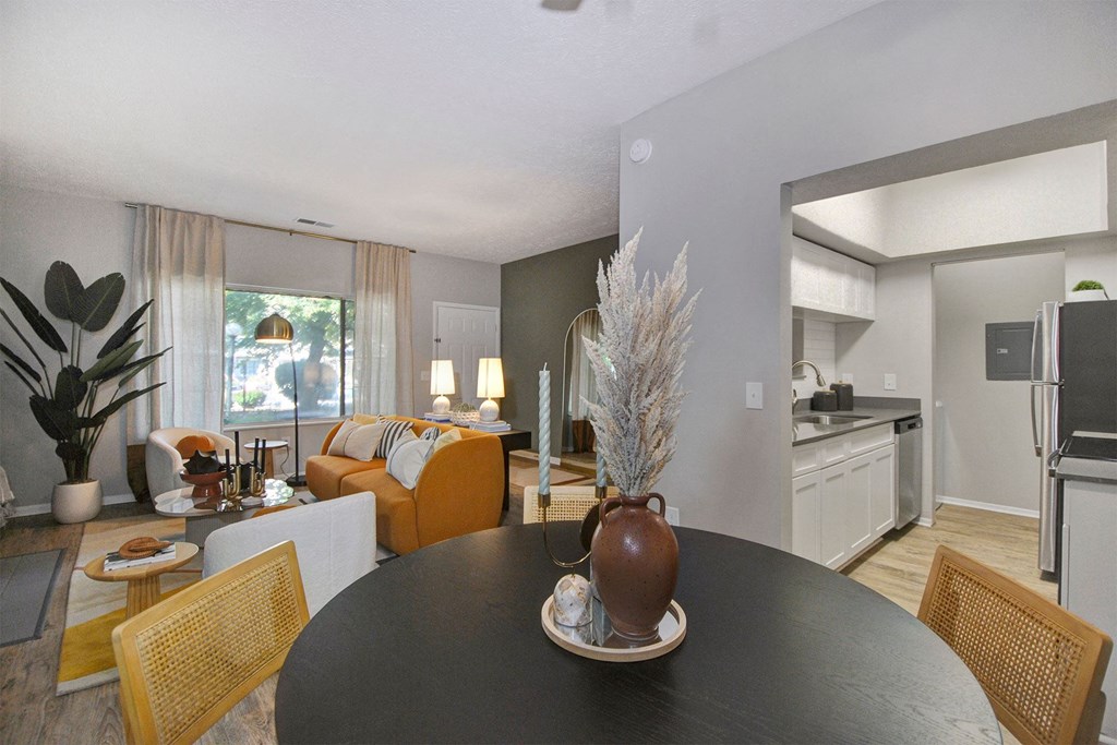 a dining room table with a vase on top of it