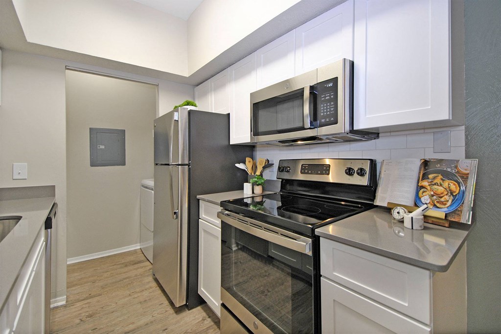 a kitchen with stainless steel appliances and a refrigerator