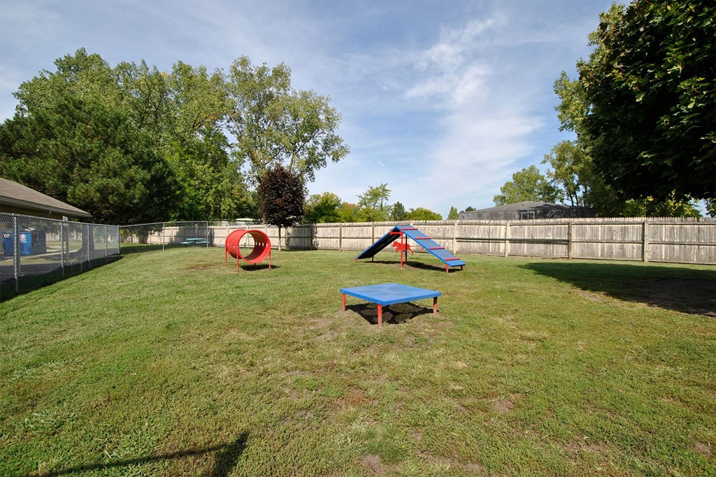 a backyard with a trampoline and a picnic table
