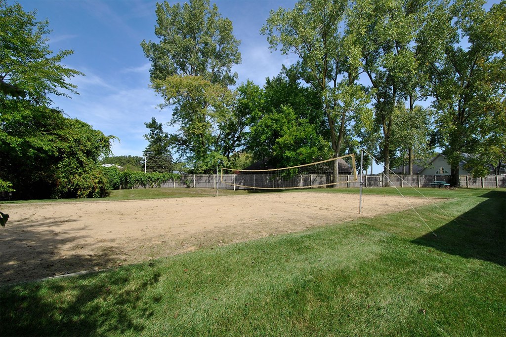 a volleyball court in the middle of a grass field