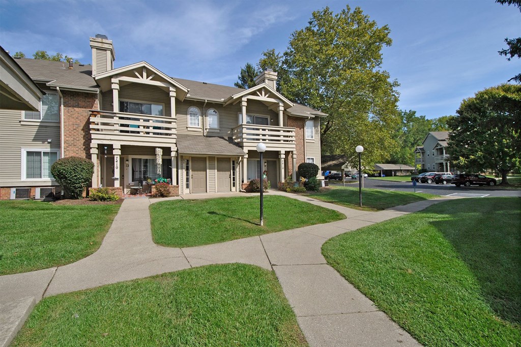 apartment building exterior with sidewalks and lamps