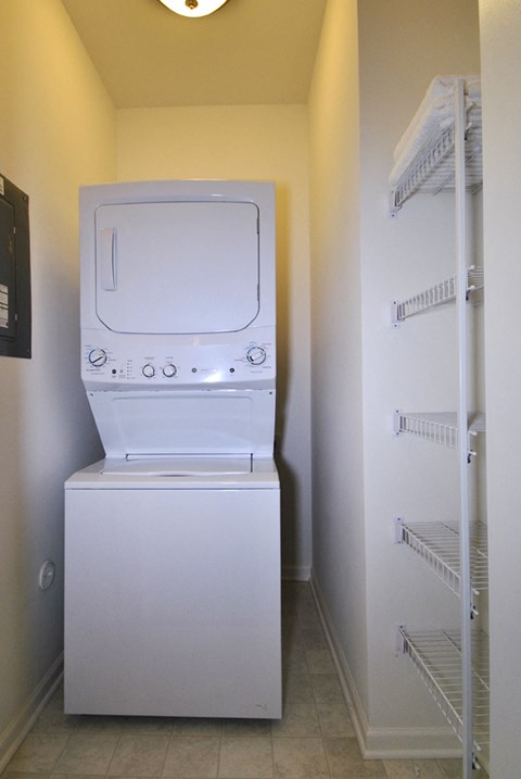 A white microwave oven is on the left and a white refrigerator is on the right.