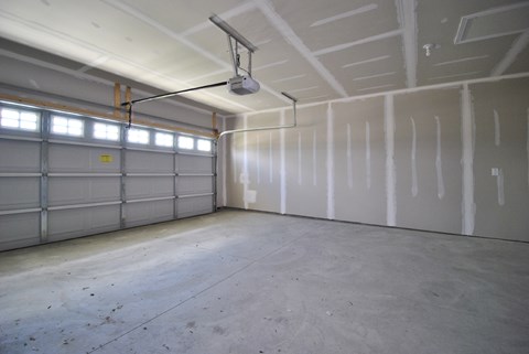 A garage with a concrete floor and white walls.