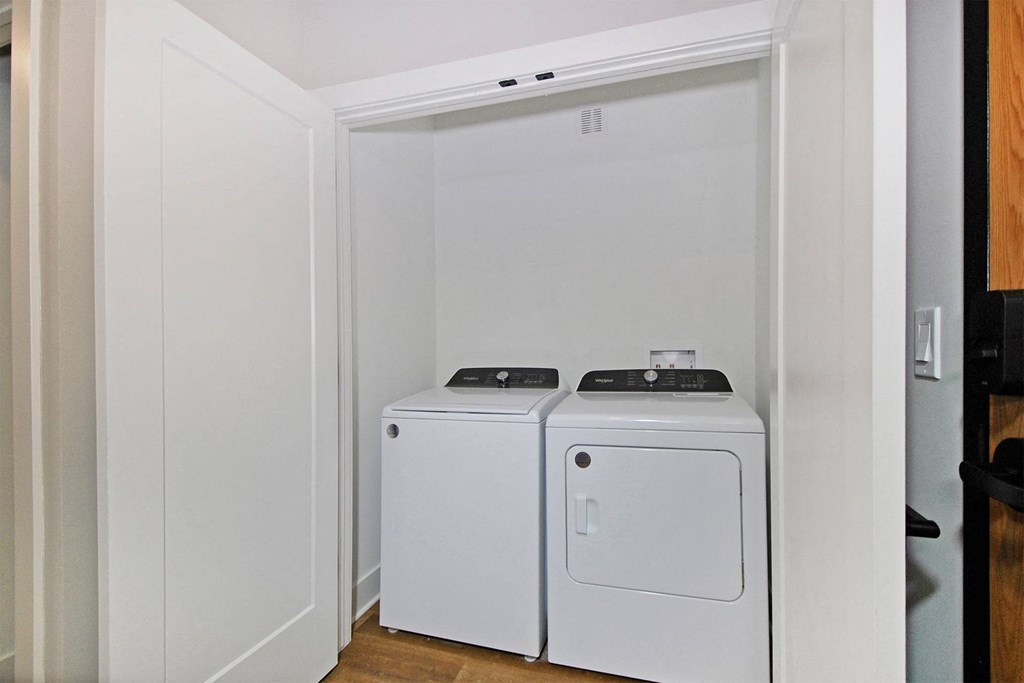 a washer and dryer in a room with white walls
