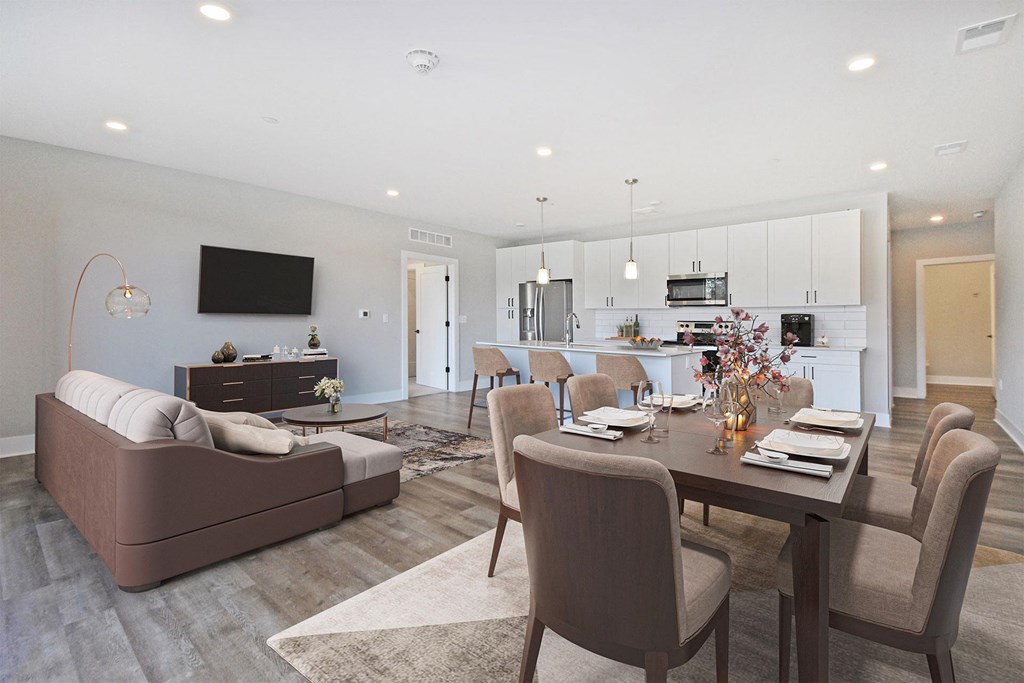 a living room and dining room with a table and chairs