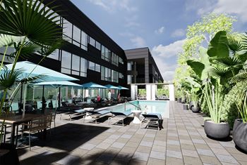 a swimming pool with chairs and umbrellas in front of a building