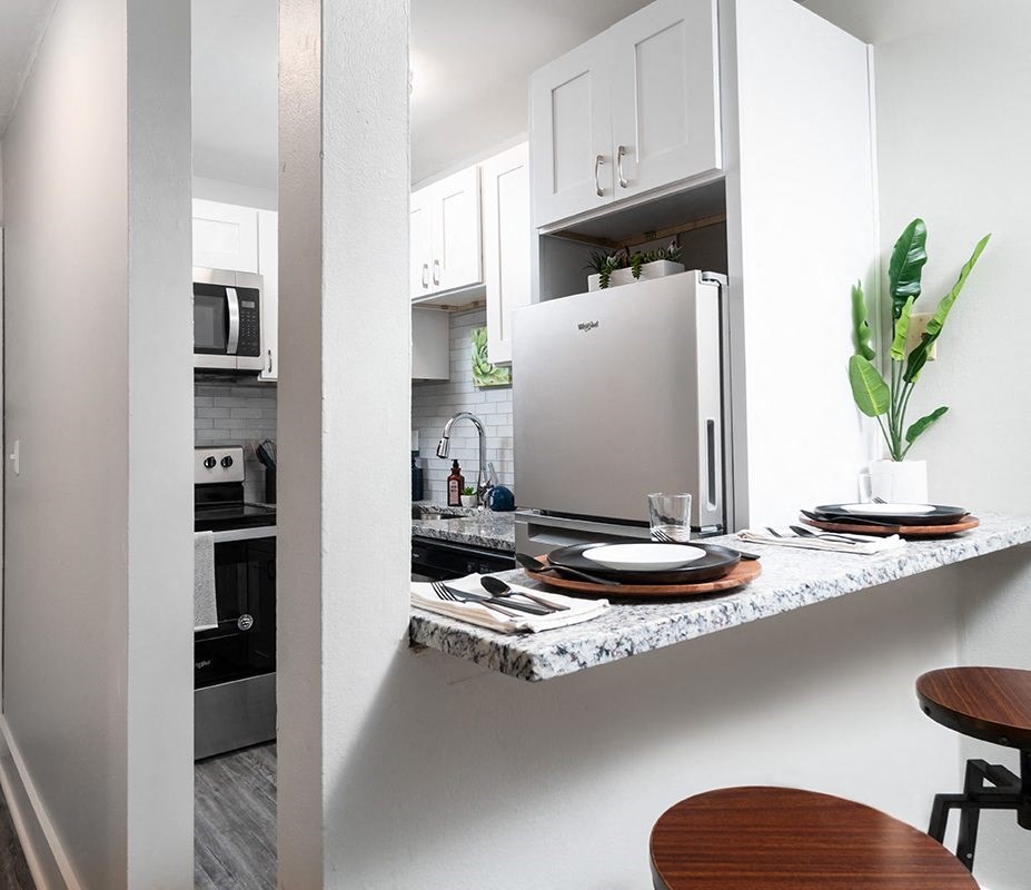 a kitchen with a counter top and a refrigerator