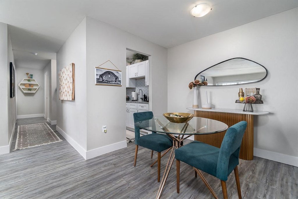 a dining room with a glass table and chairs