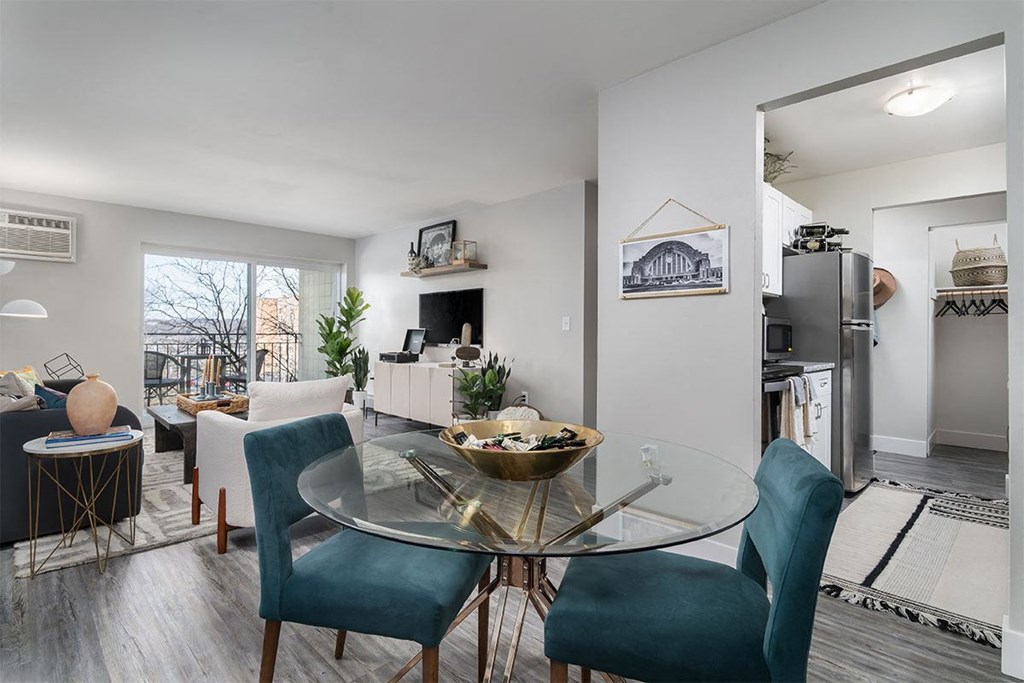 an open living room and dining room with a glass table