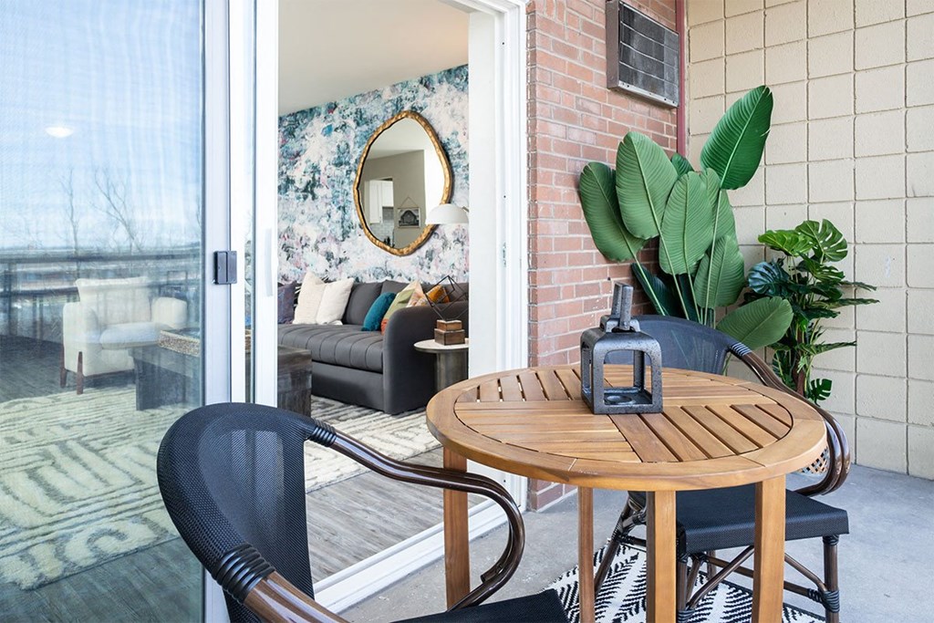 a small patio with a table and chairs