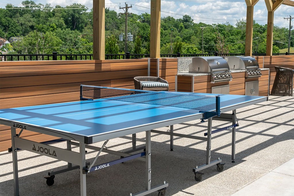 a blue ping pong table on a patio