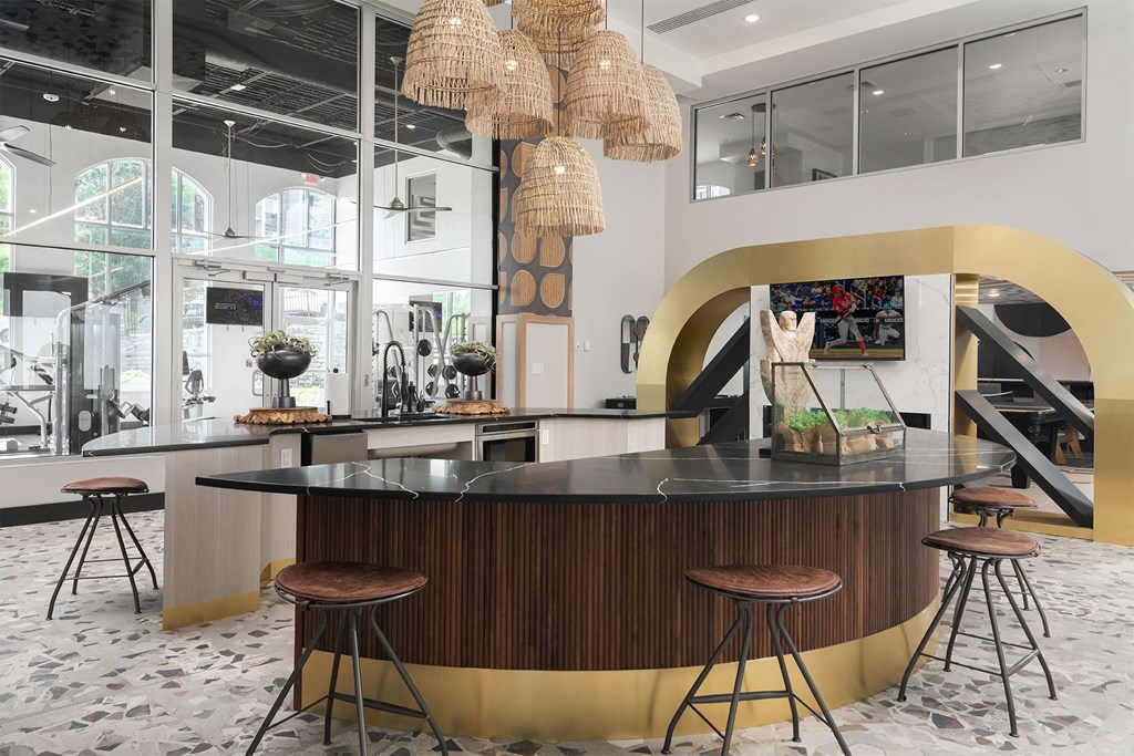 the lobby or reception area of a hotel with a bar and stools