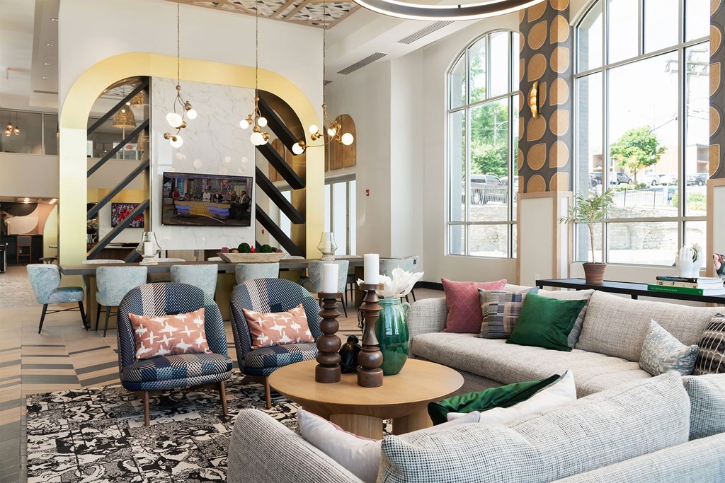 a living room with couches and chairs and a table