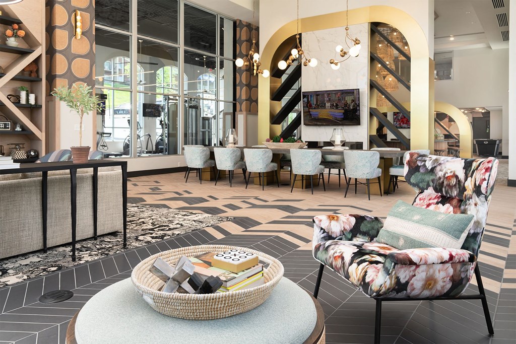 a lobby of a hotel with chairs and a table